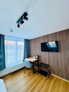 a room with a desk and a table with a chair at Haus Stadler - Self Check-in in Tauplitz