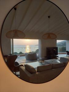 a living room with a couch and a mirror at Villa Solanella in Coti-Chiavari