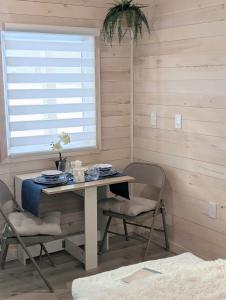 a table and chairs in a room with a window at Field and Fern Cottages in Tatamagouche +61 photos