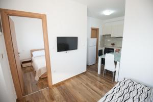 a room with a bedroom with a bed and a mirror at Apartmani Ivo 2 in Podstrana