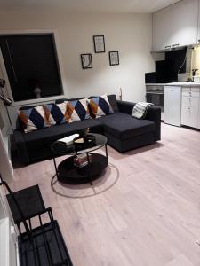 a living room with a black couch and a table at Modern Flat In Flateby, Enebakk in Flateby