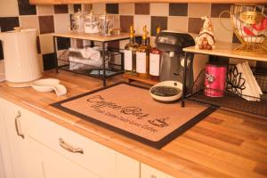 a kitchen counter with a welcome mat on a counter top at 2 Bedroom House By Travel Lets Holiday Homes Derry With Garden in Derry Londonderry