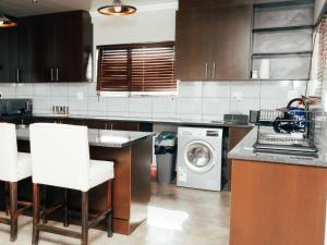 a kitchen with a washer and dryer in it at Kwagae farm in Kuruman