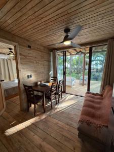a wooden dining room with a table and chairs at Hotel Oasis & Surf Camp in Santa Catalina