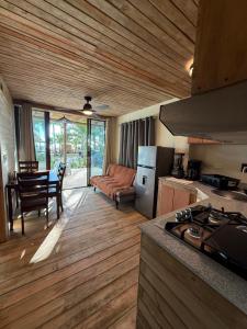 a kitchen with a stove and a living room with a table at Hotel Oasis & Surf Camp in Santa Catalina +78 photos