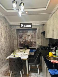 a kitchen with a table and chairs in a room at Gagarin Luxury Apartment in Samarkand