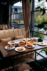 a wooden table with plates of food on it at Relax Resort in Reshetilovskiy Kut
