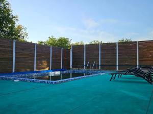 a swimming pool in front of a wooden fence at Villa Dacha in Izmail +7 photos