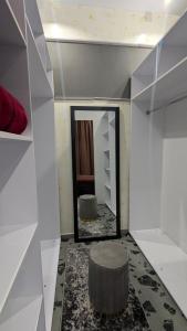 a dressing room with a mirror and a stool at Villa Dacha in Izmail