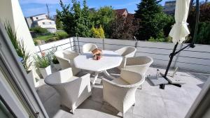 a white table and chairs on a patio at Ferienwohnung Schöne Zeit in Nordenham
