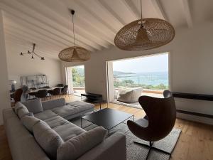 a living room with a couch and a table at Villa Solanella in Coti-Chiavari
