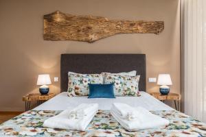 a bedroom with a bed with two towels on it at Casas De Bouro 3 Casa Do Alecrim in Terras de Bouro +34 photos