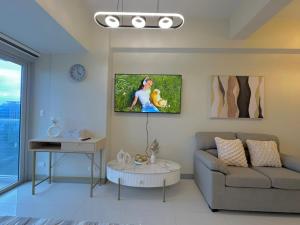 a living room with a couch and a table at 35th Prime Staycation BGC in Manila