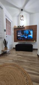 a living room with a large flat screen tv on a wall at Boho Chic Relaxing Space in Fajardo