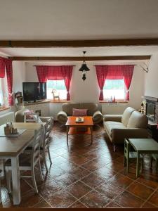 a living room with a couch and a table at Prázdninový dům u Špičáku in Albrechtice v Jizerských horách