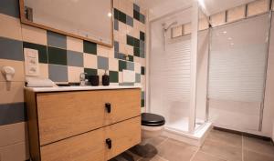 a bathroom with a toilet and a sink and a shower at Au Petit Pierrot in Spa