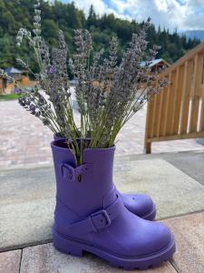 a purple rubber boots with a bouquet of lavender at Rijeka in Jahorina