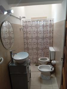 a bathroom with a sink and a toilet and a shower at Casa Esmeralda in Concordia +31 photos