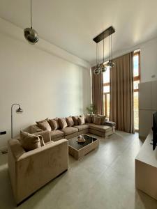 a living room with a couch and a table at Royal Loft Residence in Târgu Jiu