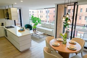 a kitchen and living room with a table and chairs at Hotel EspacioYa By Mario Rental 103 in Bogotá