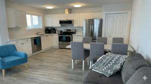 a kitchen with a couch and a table with chairs at True Ski-In-Ski-Out Rare 3-Bed Condo in Mount Washington