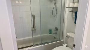 a bathroom with a shower and a toilet at True Ski-In-Ski-Out Rare 3-Bed Condo in Mount Washington