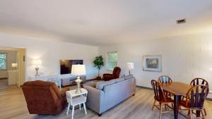 a living room with a couch and a table at Atlantic Breeze #8 in Jekyll Island
