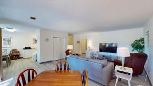 a living room with a couch and a table at Atlantic Breeze #8 in Jekyll Island