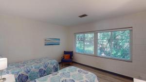 a bedroom with two beds and a window at Atlantic Breeze #8 in Jekyll Island