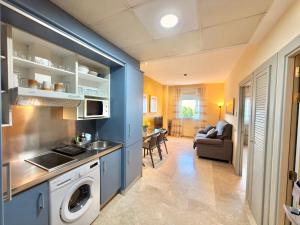 a kitchen with a washer and dryer in a room at ApartSur® in Bormujos