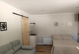 a living room with a bed and a couch at Hospedaje Costanera del Sol in La Adela