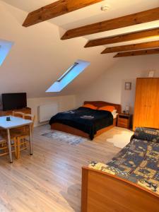 a bedroom with two beds and a table in a room at Villa Apartments in Palanga