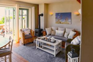 a living room with a couch and a stove at BEACHHOUSE Fehmarn in Fehmarn