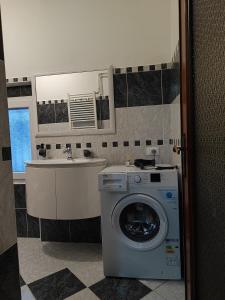 a bathroom with a washing machine and a sink at Margherita in Seriate