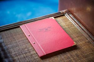 a red notebook sitting on top of a table at Koura Lodge in Rotorua