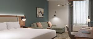 a bedroom with a bed and a living room at Hawthorn Extended Stay by Wyndham Kilgore in Kilgore