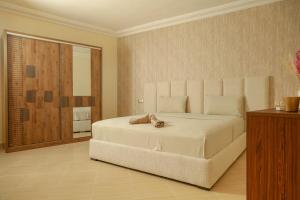 a bedroom with a bed with a teddy bear on it at Residence Issrae I in Nador