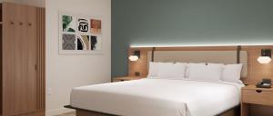 a bedroom with a large white bed with white pillows at Hawthorn Extended Stay by Wyndham Kilgore in Kilgore