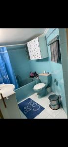 a bathroom with a toilet and a sink and a tub at Master private room in shared appartement in Athens +19 photos