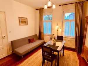 a living room with a couch and a table at Wohlfühlwohnung Dauborn in Hünfelden