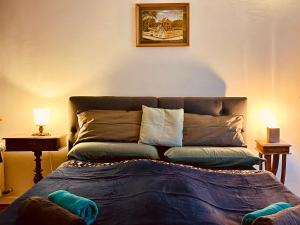 a bedroom with a bed with a blue blanket at Wohlfühlwohnung Dauborn in Hünfelden +19 photos