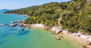 an aerial view of a beach with people in the water at Garcida in Governador Celso Ramos