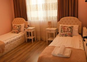 a bedroom with two beds and a window at Guest House Dinaya in Dobrinishte +47 photos