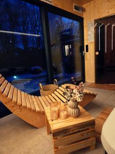 a wooden boat sitting on top of a patio at APARTAMENT MIERZYN Sauna & Jacuzzi in Mierzyn