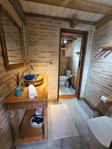 a bathroom with a sink and a toilet in a room at Recanto Curiaçu in Cunha +105 photos