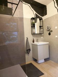 a bathroom with a sink and a glass shower at Ferienhaus Lyś in Lauta