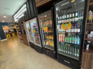 two refrigerators in a store with drinks in them at Florida Limeira Hotel in Limeira