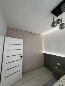 a bedroom with white walls and a white door at Deluxe 3 in Timişoara