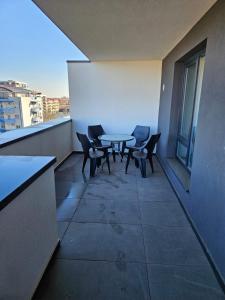a room with a table and chairs on a balcony at Deluxe 3 in Timişoara