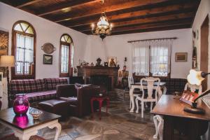 a living room with a couch and a table at Sea View Traditional Villa in Vourvourou